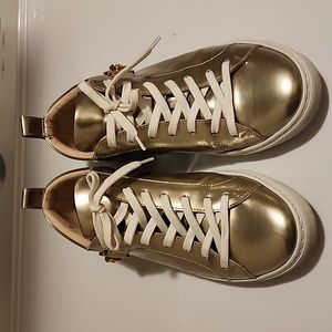 Versace gold sneaker size 37 eu. I am a size 8 women and I can fit them.